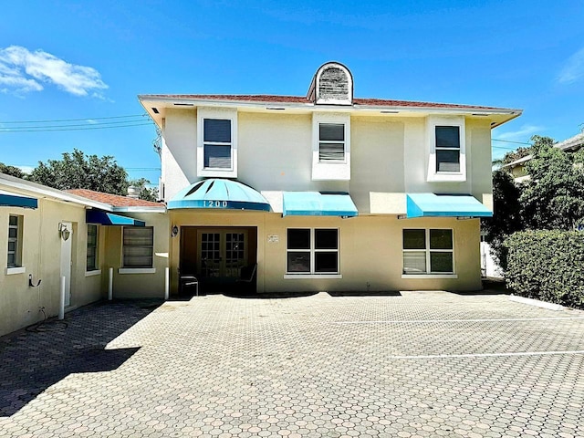 1200 Surf Rd, Singer Island, FL 33404 - view of front of property with french doors, a patio, and stucco siding