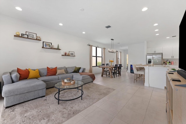 16390 Sea Turtle Pl, The Acreage, FL 33470 - living room with recessed lighting, a chandelier, visible vents, and light tile patterned floors