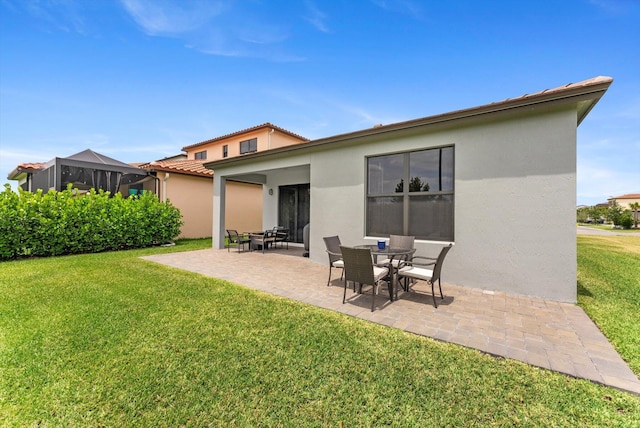 16390 Sea Turtle Pl, The Acreage, FL 33470 - back of property featuring a yard, a tiled roof, a patio, and stucco siding