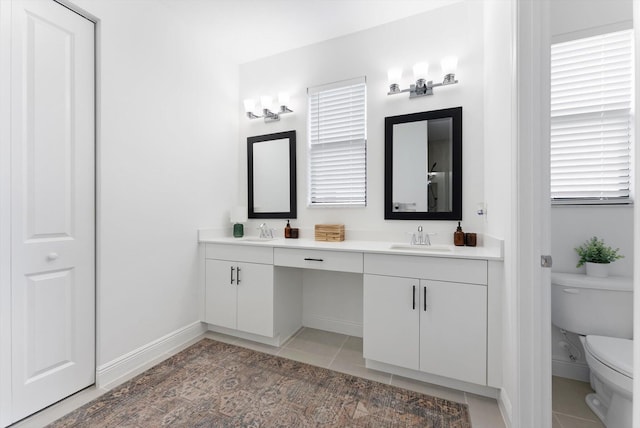 16390 Sea Turtle Pl, The Acreage, FL 33470 - bathroom with tile patterned flooring, baseboards, a sink, and toilet