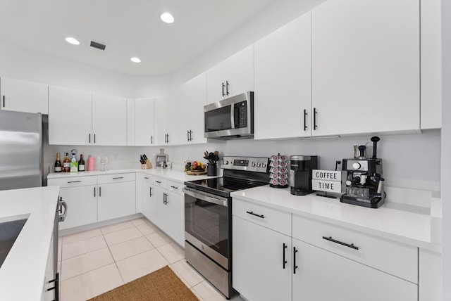 16390 Sea Turtle Pl, The Acreage, FL 33470 - kitchen featuring white cabinetry, stainless steel appliances, visible vents, and light countertops
