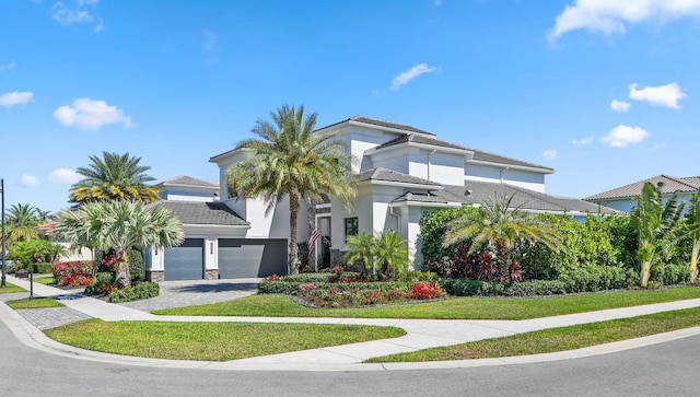 2560 NW 70th Blvd, Boca Raton, FL 33496 - view of front of property featuring a tile roof, decorative driveway, an attached garage, stucco siding, and a front lawn