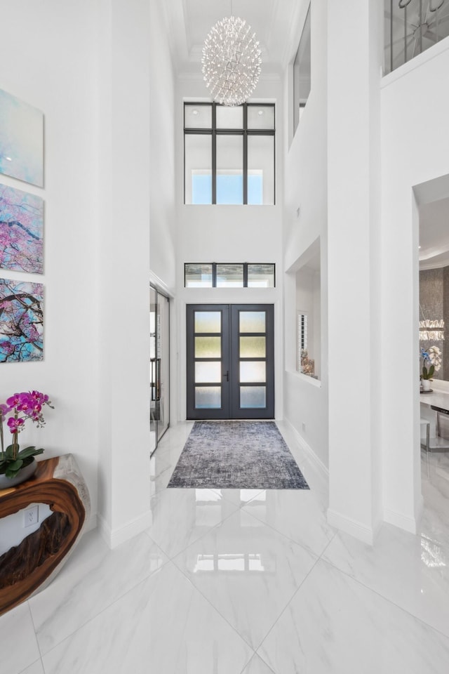 2560 NW 70th Blvd, Boca Raton, FL 33496 - foyer entrance with a chandelier, marble finish floor, and baseboards