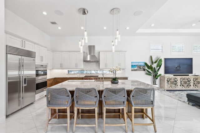 2560 NW 70th Blvd, Boca Raton, FL 33496 - kitchen with stainless steel appliances, marble finish floor, backsplash, visible vents, and wall chimney exhaust hood
