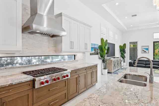 2560 NW 70th Blvd, Boca Raton, FL 33496 - kitchen featuring wall chimney range hood, tasteful backsplash, a sink, recessed lighting, and stainless steel gas cooktop