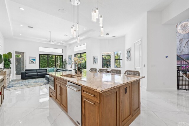 2560 NW 70th Blvd, Boca Raton, FL 33496 - kitchen with brown cabinets, a sink, ceiling fan, stainless steel appliances, and a tray ceiling
