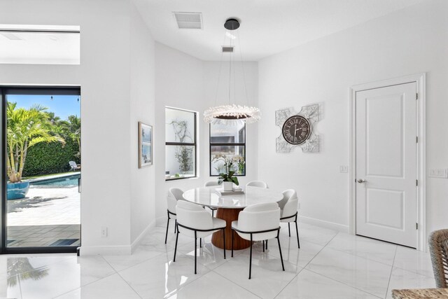 2560 NW 70th Blvd, Boca Raton, FL 33496 - dining room with baseboards, visible vents, marble finish floor, and a towering ceiling