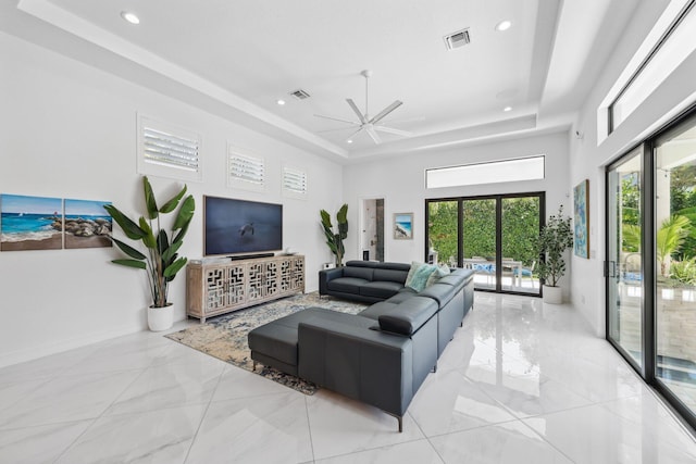 2560 NW 70th Blvd, Boca Raton, FL 33496 - living room with visible vents, a ceiling fan, a tray ceiling, and recessed lighting