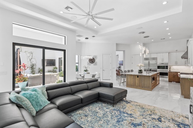 2560 NW 70th Blvd, Boca Raton, FL 33496 - living area featuring a raised ceiling, visible vents, recessed lighting, and marble finish floor