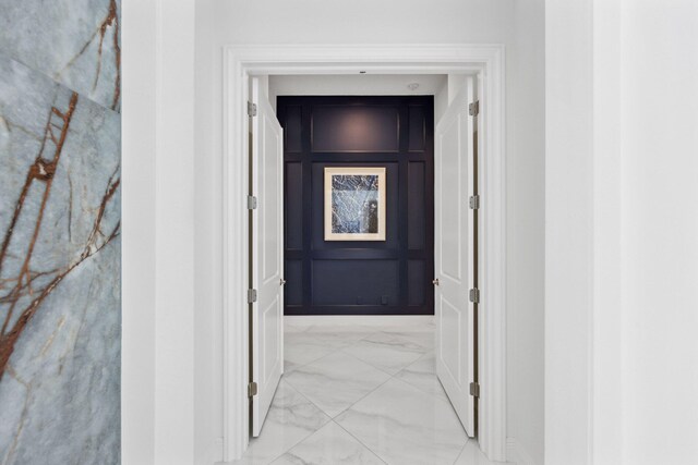2560 NW 70th Blvd, Boca Raton, FL 33496 - hall featuring marble finish floor and a decorative wall