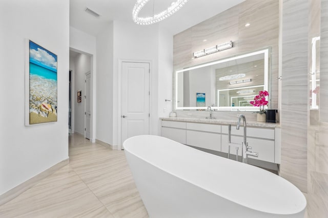 2560 NW 70th Blvd, Boca Raton, FL 33496 - full bath with vanity, visible vents, a soaking tub, and baseboards
