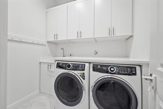 2560 NW 70th Blvd, Boca Raton, FL 33496 - laundry room featuring washer and dryer, cabinet space, marble finish floor, a sink, and baseboards