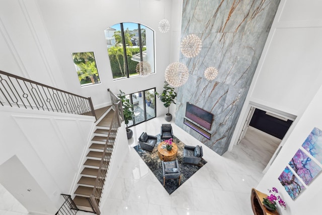 2560 NW 70th Blvd, Boca Raton, FL 33496 - living room featuring a towering ceiling, marble finish floor, stairway, and a high end fireplace