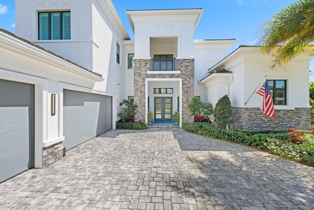 2560 NW 70th Blvd, Boca Raton, FL 33496 - view of front of property with french doors, stucco siding, and stone siding