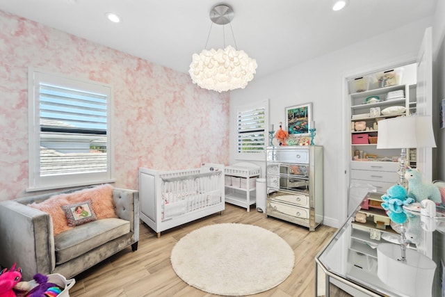 2560 NW 70th Blvd, Boca Raton, FL 33496 - bedroom with wallpapered walls, wood finished floors, and recessed lighting