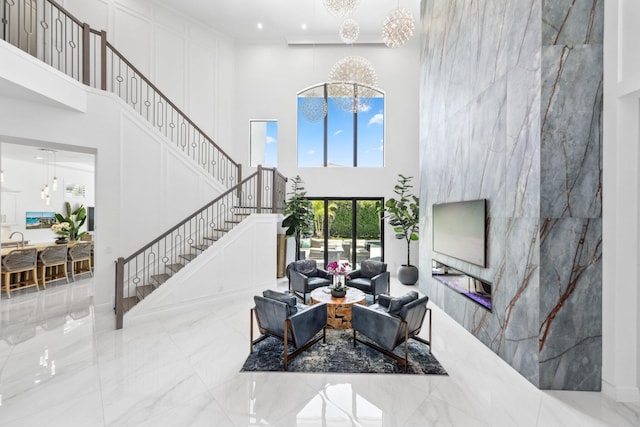 2560 NW 70th Blvd, Boca Raton, FL 33496 - living area with recessed lighting, stairs, a high ceiling, and marble finish floor