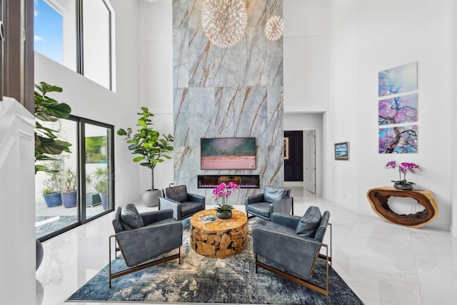 2560 NW 70th Blvd, Boca Raton, FL 33496 - living area with a high end fireplace, a high ceiling, marble finish floor, and baseboards