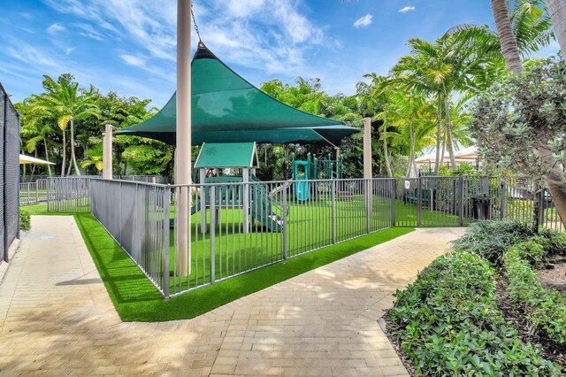2560 NW 70th Blvd, Boca Raton, FL 33496 - view of community featuring a lawn, playground community, and fence