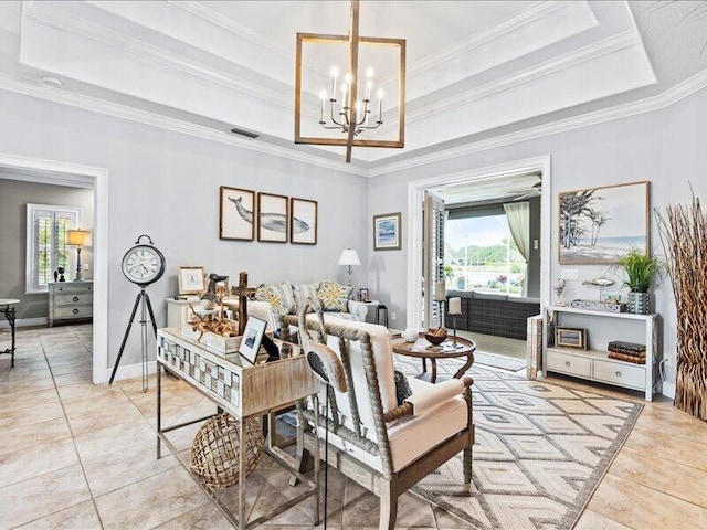 living area with a healthy amount of sunlight, a tray ceiling, and visible vents