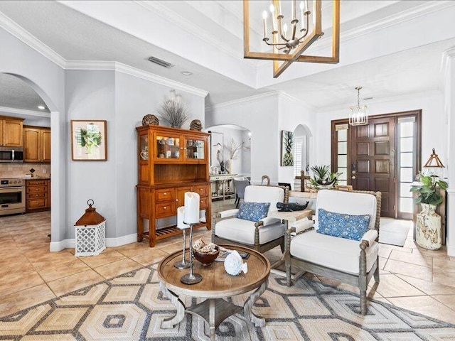 sitting room featuring visible vents, arched walkways, and a chandelier