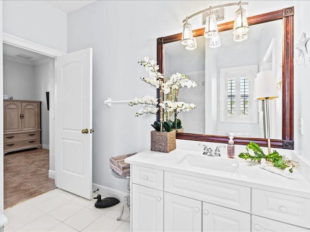 bathroom featuring baseboards, tile patterned flooring, and vanity