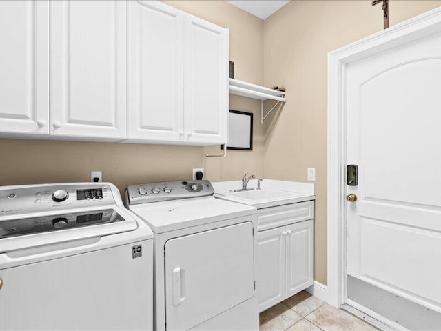 clothes washing area featuring a sink, separate washer and dryer, light tile patterned flooring, and cabinet space