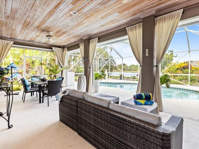 view of patio with a lanai, ceiling fan, an outdoor living space, and an outdoor pool