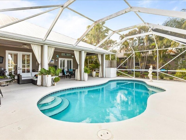 pool with french doors and a patio area