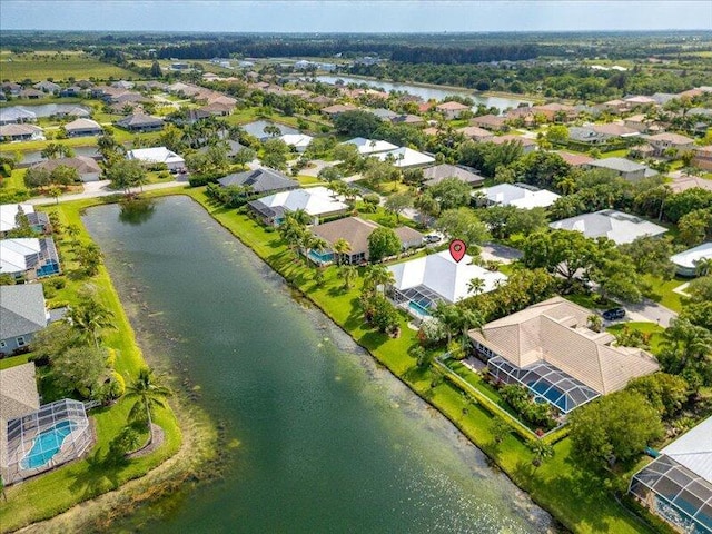 birds eye view of property featuring a water view and a residential view