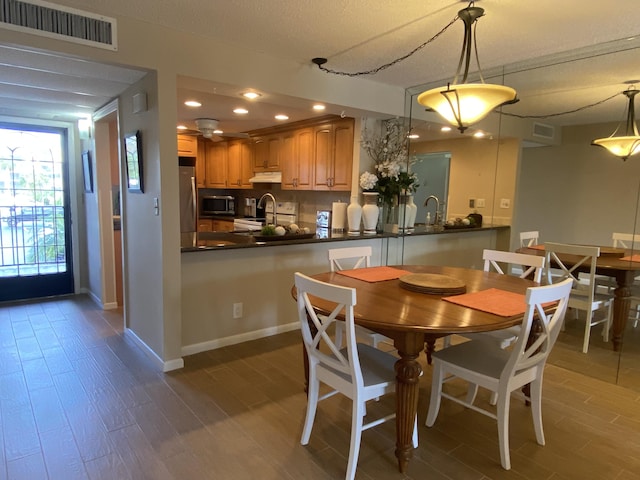 7 Royal Palm Way Unit 202, Boca Raton, FL 33432 - dining space with wood finished floors and recessed lighting