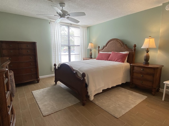 7 Royal Palm Way Unit 202, Boca Raton, FL 33432 - bedroom with light wood finished floors, a textured ceiling, and a ceiling fan