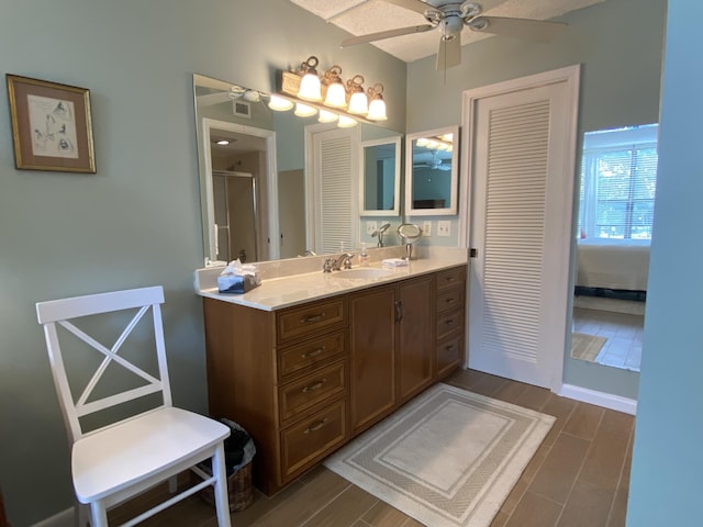 7 Royal Palm Way Unit 202, Boca Raton, FL 33432 - bathroom featuring ceiling fan, vanity, wood finished floors, and a shower stall