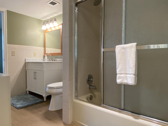 7 Royal Palm Way Unit 202, Boca Raton, FL 33432 - bathroom with vanity, tile walls, wood finished floors, shower / bath combination with glass door, and wainscoting