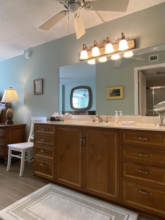 7 Royal Palm Way Unit 202, Boca Raton, FL 33432 - full bathroom featuring double vanity, wood finished floors, ceiling fan, and a shower with door
