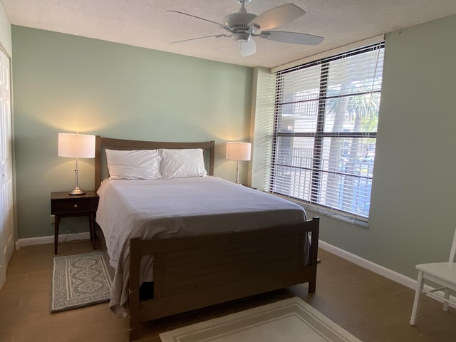 7 Royal Palm Way Unit 202, Boca Raton, FL 33432 - bedroom featuring multiple windows, a textured ceiling, and ceiling fan