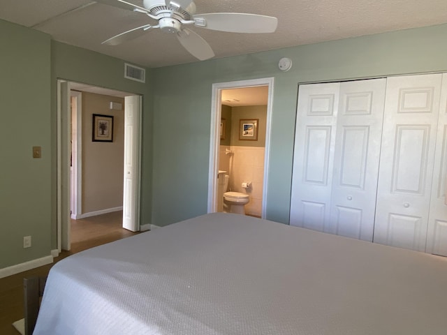 7 Royal Palm Way Unit 202, Boca Raton, FL 33432 - bedroom featuring a closet, connected bathroom, and ceiling fan