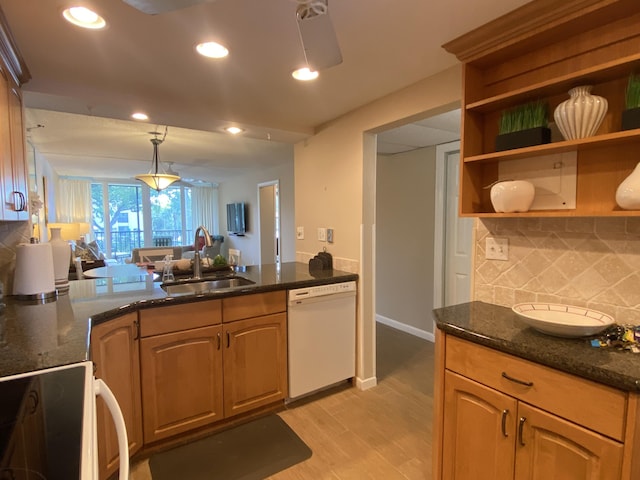 7 Royal Palm Way Unit 202, Boca Raton, FL 33432 - kitchen featuring white dishwasher, range, decorative backsplash, light wood-type flooring, and dark stone counters