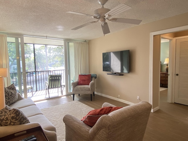 7 Royal Palm Way Unit 202, Boca Raton, FL 33432 - living room with hardwood / wood-style flooring, a textured ceiling, and a ceiling fan