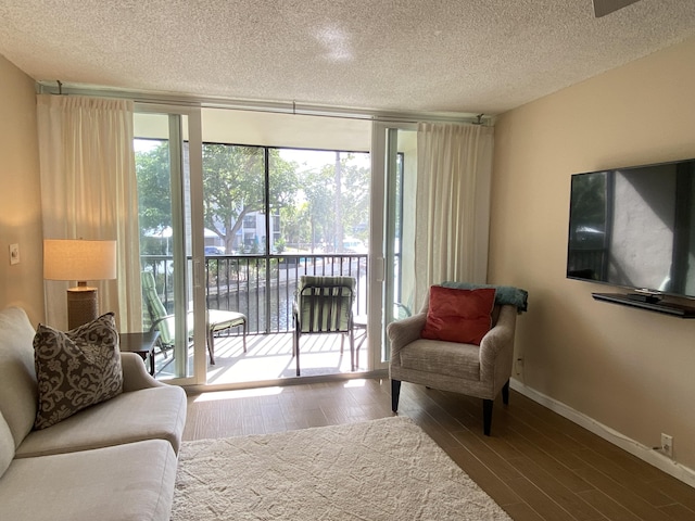 7 Royal Palm Way Unit 202, Boca Raton, FL 33432 - living area featuring wood finished floors and a textured ceiling