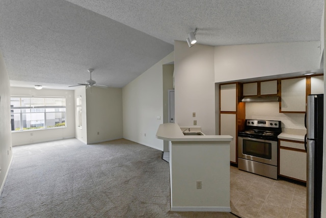 kitchen featuring stainless steel appliances, under cabinet range hood, light countertops, ceiling fan, and a textured ceiling