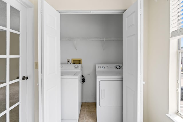 laundry area with light tile patterned floors, washer and dryer, and laundry area