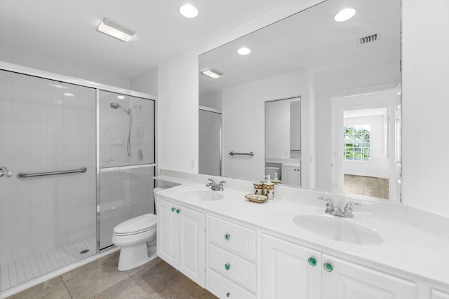 bathroom with toilet, visible vents, a sink, and a stall shower