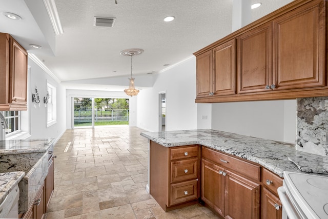 kitchen featuring stone tile floors, light stone countertops, brown cabinetry, and ornamental molding