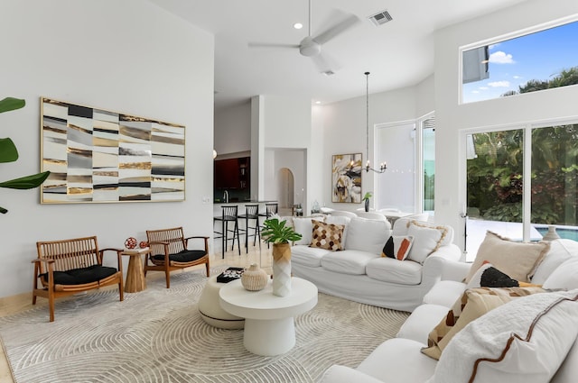 6247 NW 33rd Ave, Boca Raton, FL 33496 - living area with visible vents, a high ceiling, and ceiling fan