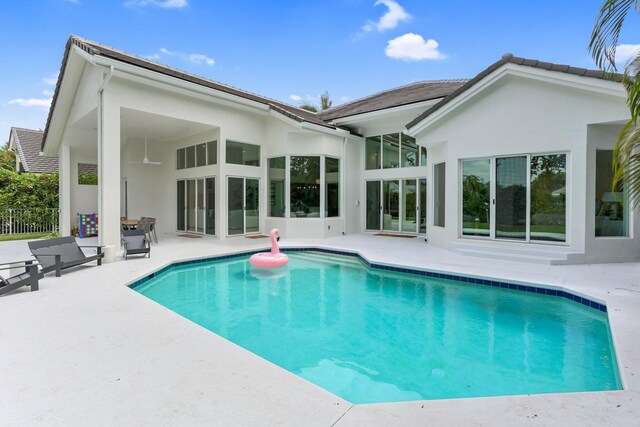6247 NW 33rd Ave, Boca Raton, FL 33496 - rear view of house featuring an outdoor pool, a patio, and stucco siding