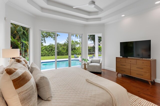 6247 NW 33rd Ave, Boca Raton, FL 33496 - bedroom featuring multiple windows, dark wood finished floors, a raised ceiling, and access to exterior