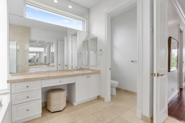 6247 NW 33rd Ave, Boca Raton, FL 33496 - bathroom with baseboards, a wealth of natural light, toilet, and vanity