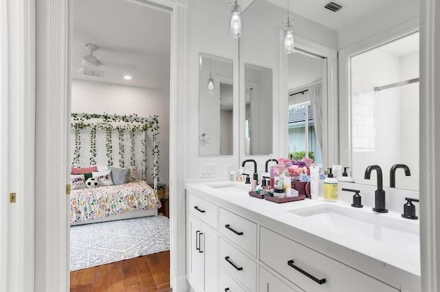 6247 NW 33rd Ave, Boca Raton, FL 33496 - ensuite bathroom featuring wood finished floors, a sink, visible vents, and ensuite bathroom