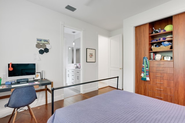 6247 NW 33rd Ave, Boca Raton, FL 33496 - bedroom featuring connected bathroom, baseboards, wood finished floors, and visible vents