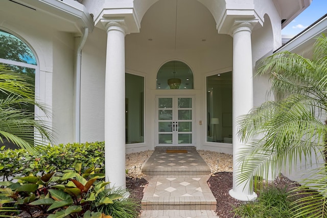 6247 NW 33rd Ave, Boca Raton, FL 33496 - view of exterior entry featuring french doors and stucco siding